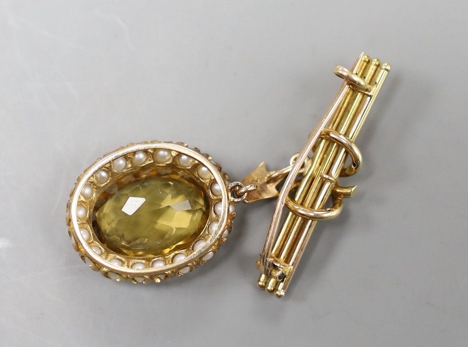 An early 20th century yellow metal, citrine and split pearl set oval pendant, overall 33mm, on a yellow metal suspension bar brooch, gross weight 8.9 grams.